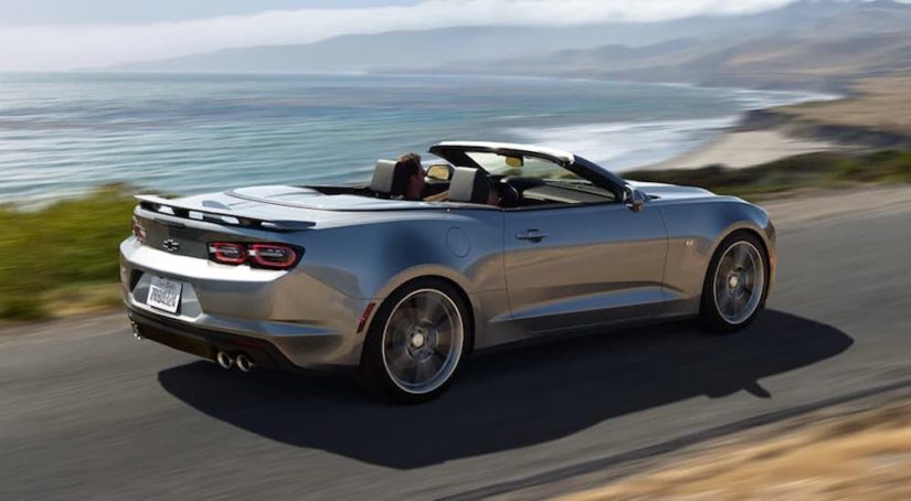A silver 2021 Chevy Camaro SS Convertible is shown from the rear at an angle.