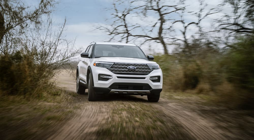 A white 2022 Ford Explorer King Ranch is shown from the front while off-road.