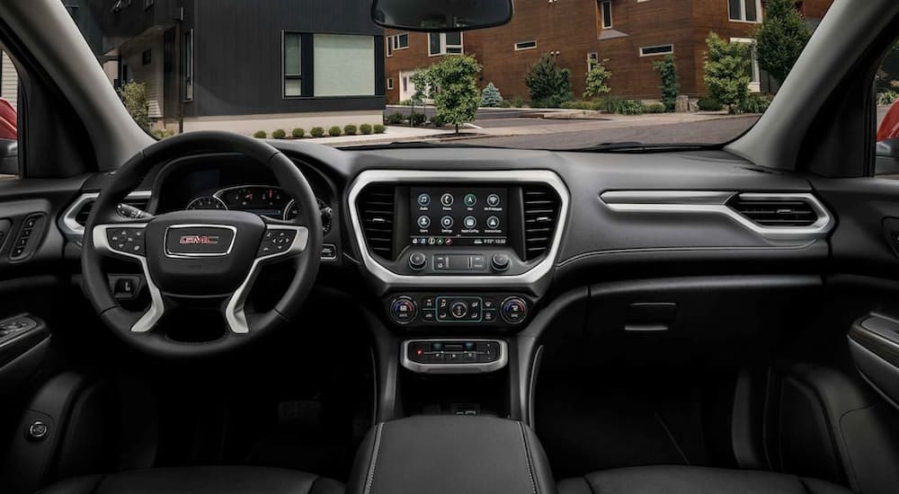 The dashboard and center console of a 2022 GMC Acadia SLE is shown.
