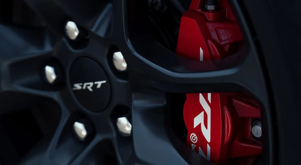 A close up shows the black rim and red caliper on a 2023 Dodge Durango SRT.