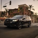 A black 2023 Subaru Ascent is shown from the front at an angle on a city street.