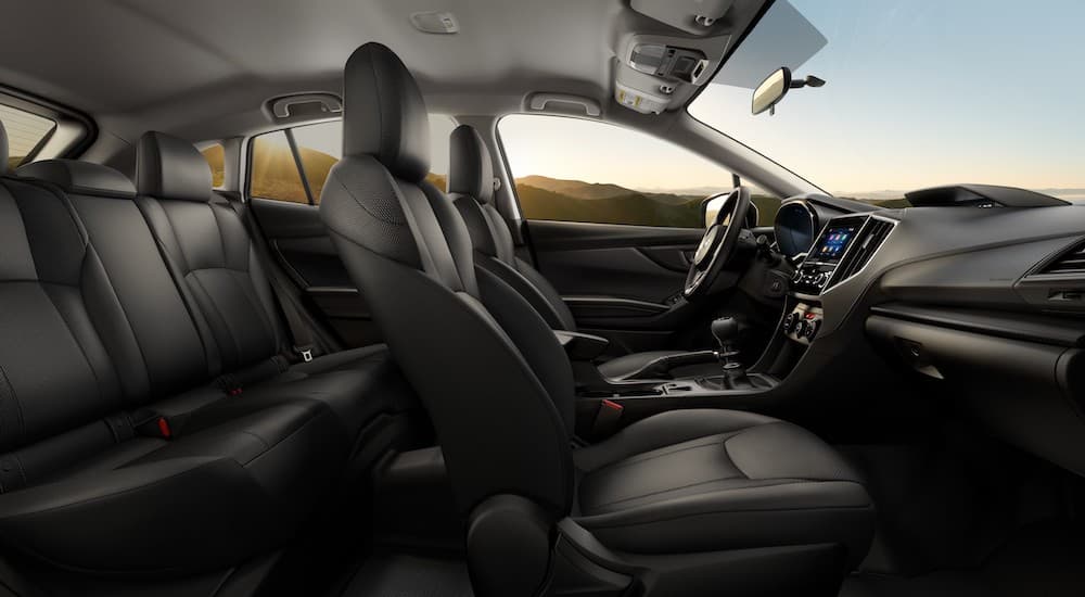 The black interior of a 2023 Subaru Crosstrek is shown from the passenger side.