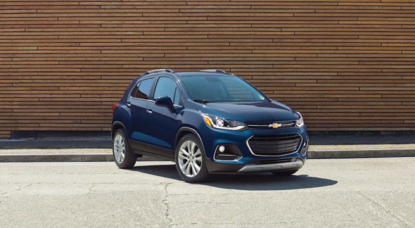 A blue 2018 Chevy Trax is shown parked at a certified used Chevy dealer.