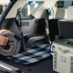 Outdoor gear is shown being loaded into the trunk of a 2022 Hyundai Palisade.