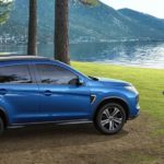 A blue 2022 Mitsubishi RVR is shown parked next to a lake.