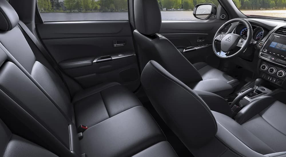 The black interior of a 2022 Mitsubishi RVR for sale shows two rows of seating.  