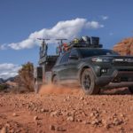 A green 2022 Ford Explorer Timberline is shown from the front at an angle while driving off-road.