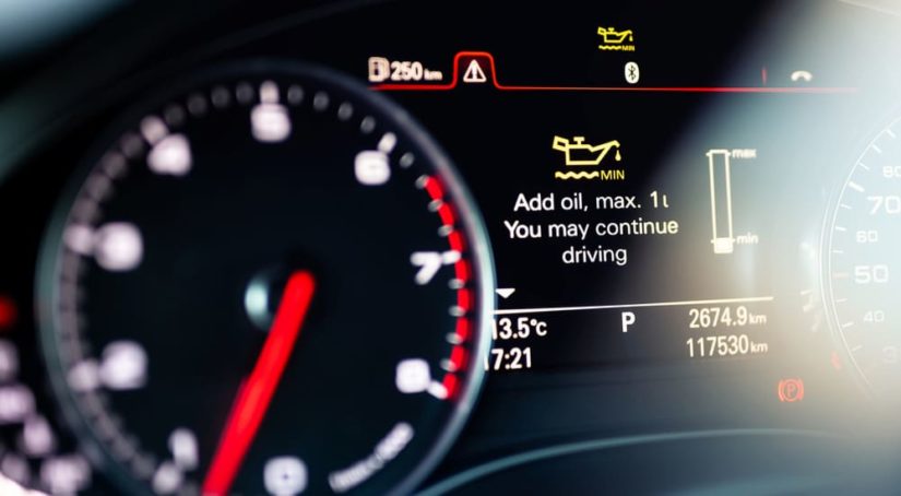 Car dashboard lights are shown with an oil warning.