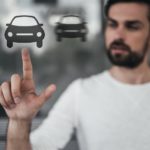 A man is shown looking at online car sales.