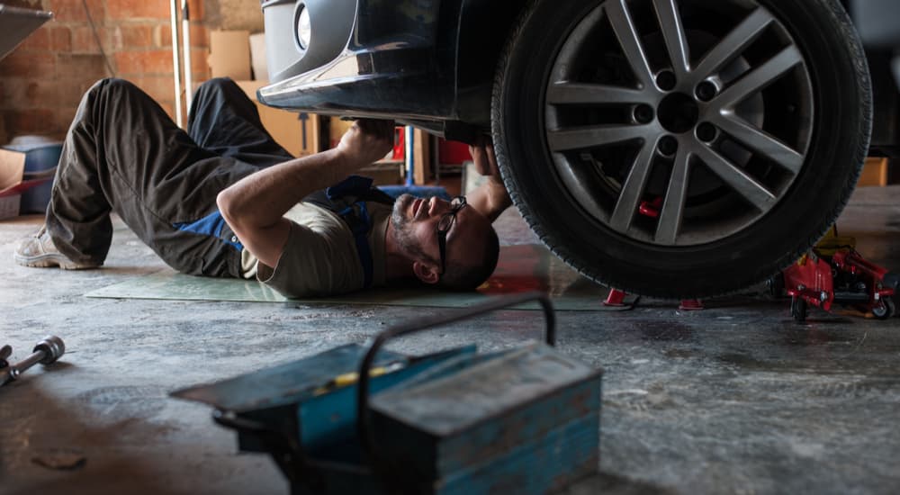 A person is shown inspecting a car bumper.