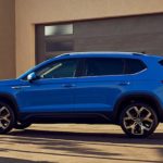 A blue 2022 Volkswagen Taos is shown from the side during a 2022 Volkswagen Taos vs 2022 Kia Seltos comparison.