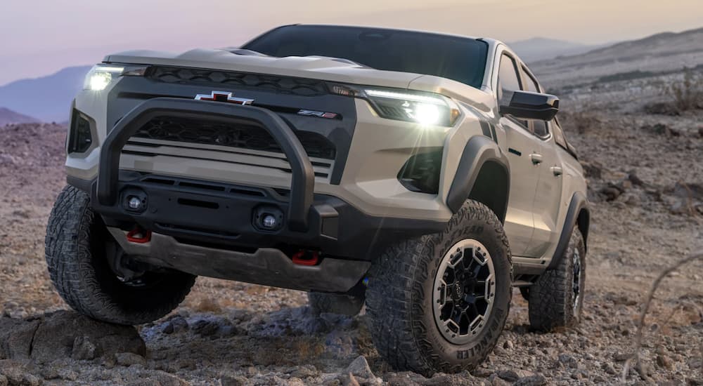 A tan 2023 Chevy Colorado ZR2 is shown parked at sunset during a 2023 Chevy Colorado vs 2023 Honda Ridgeline comparison.
