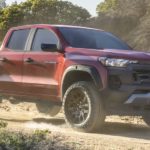 2023 Chevy Colorado Trail Boss is shown from the side parked on a dirt trail.