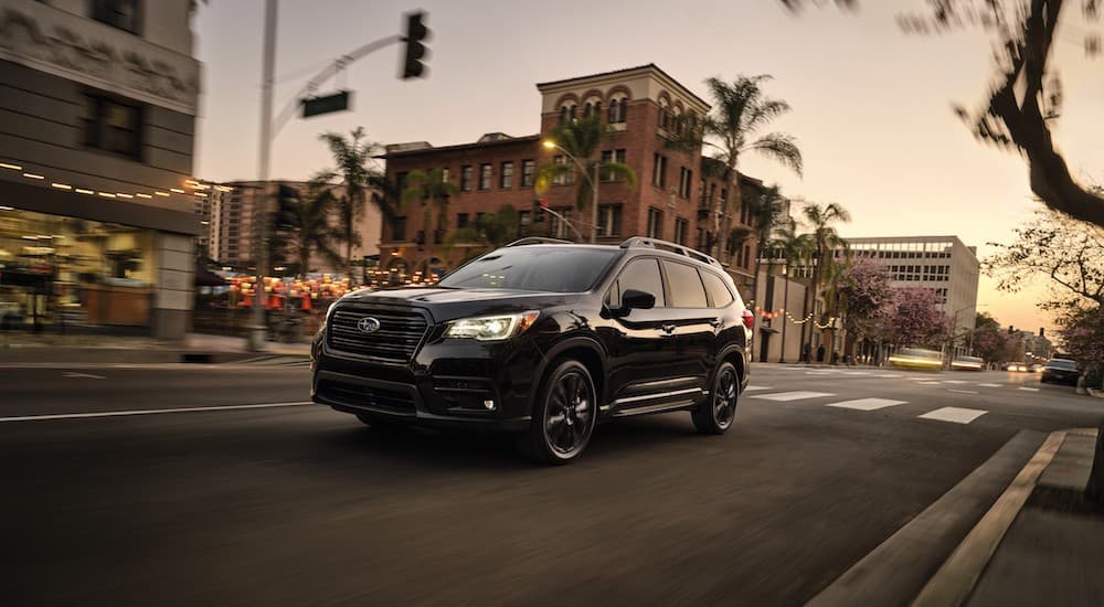 A black 2021 Subaru Ascent is shown from the front at an angle on a city street.
