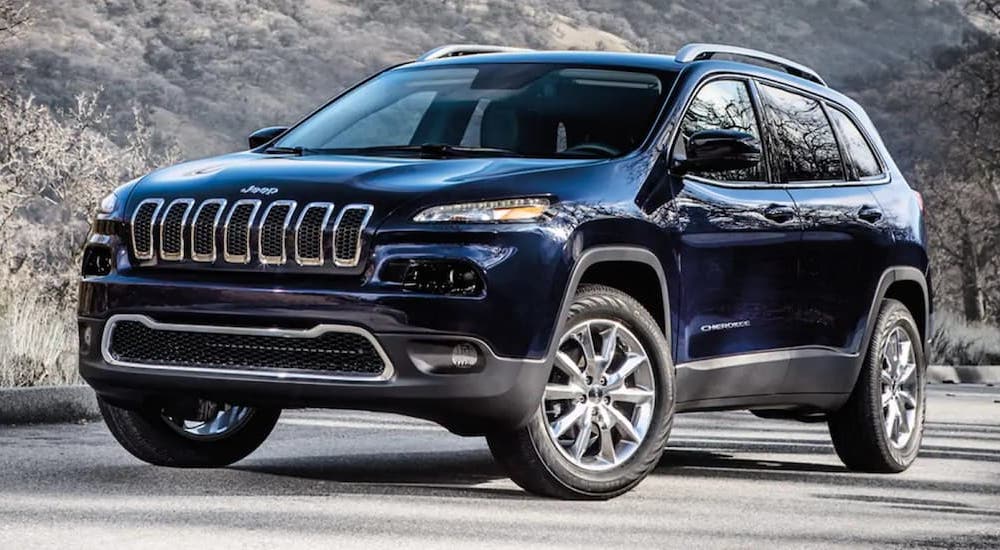A dark blue 2018 Jeep Cherokee Latitude Plus is shown parked on pavement.