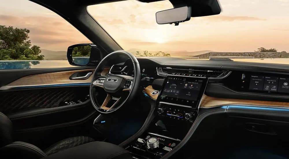 The black interior of a 2022 Jeep Grand Cherokee 4xe shows the steering wheel.