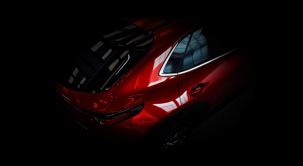 A close up shows the rear passenger side of a red 2022 Mazda CX-30.