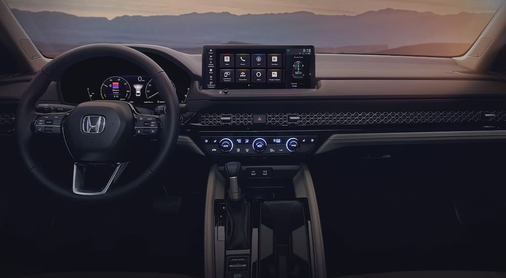 The steering wheel and dashboard of a 2023 Honda Accord is shown.