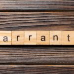 A row of wooden block spells out 'warranty.'