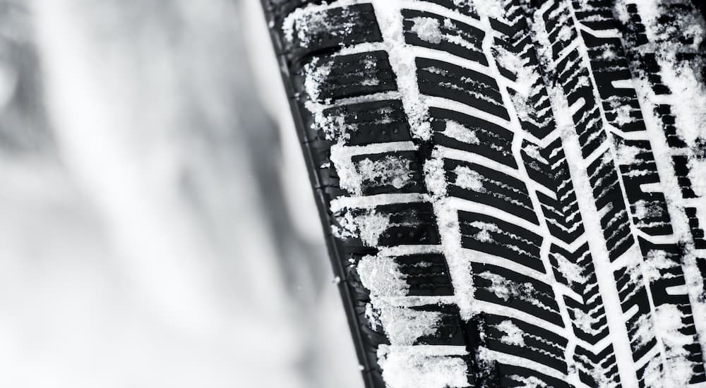 A winter tire is shown in close up.