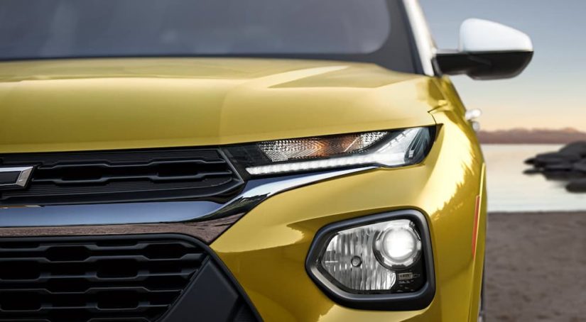A close up shows driver side headlight on a yellow 2023 Chevy Trailblazer ACTIV.