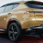 A yellow 2023 Dodge Hornet is shown from the rear.
