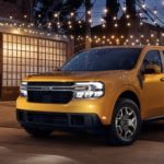 A yellow 2023 Ford Maverick is shown from the side parked at night.