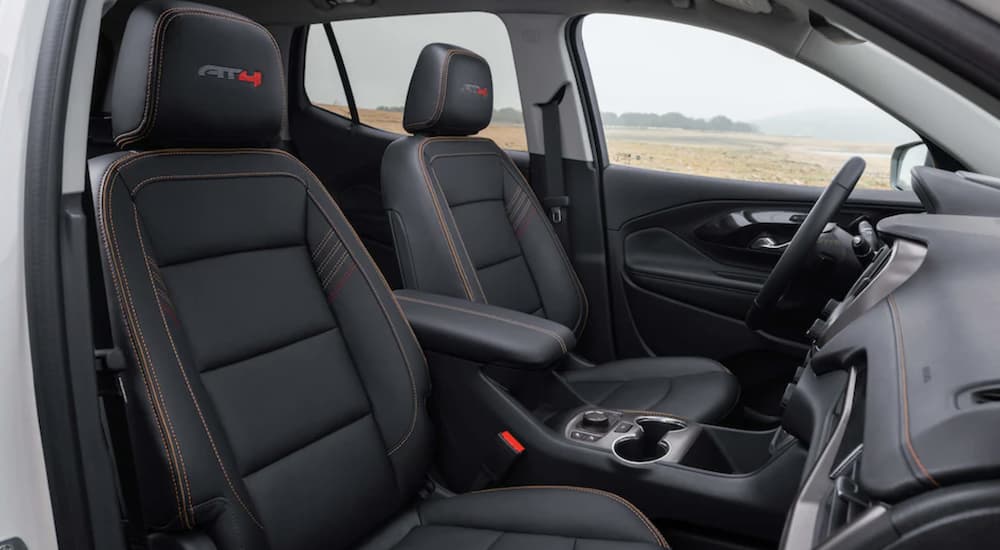 The black interior of a 2023 GMC Terrain AT4 shows the front seats.