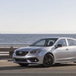 A silver 2023 Subaru Legacy Sport is shown from the front at an angle on a coast.