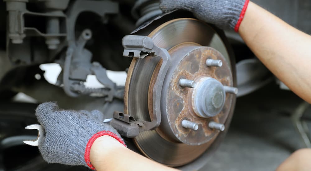 A mechanic is shown performing a brake change near you.