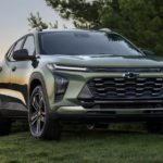 A green 2024 Chevy Trax is shown parked on a field.