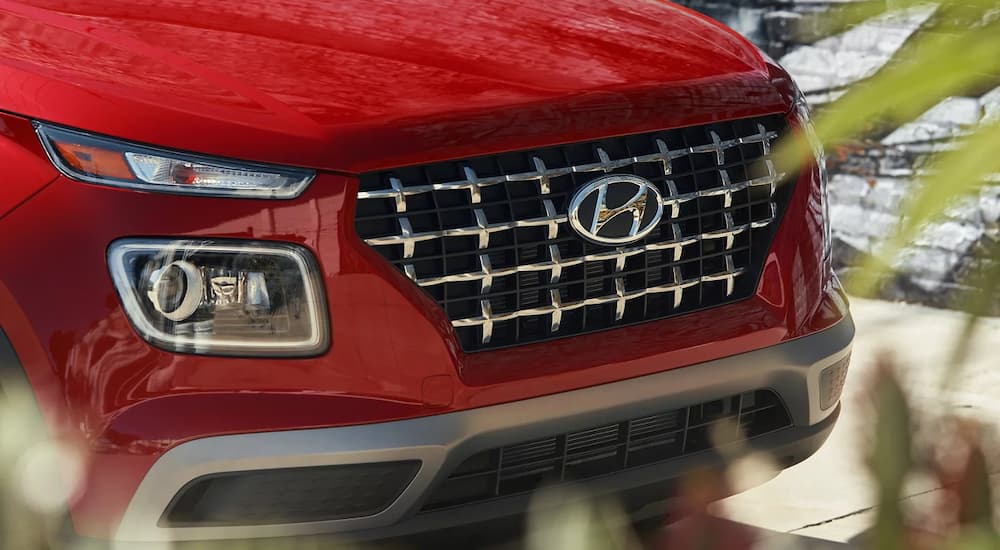 A close up of the grille on a red 2022 Hyundai Venue is shown.
