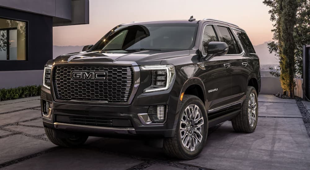 A black 2023 GMC Yukon Denali is shown from the front parked at sunset after leaving a GMC dealer.