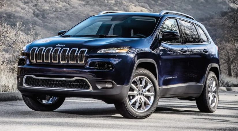 A blue 2017 Jeep Cherokee is shown parked in a lot.