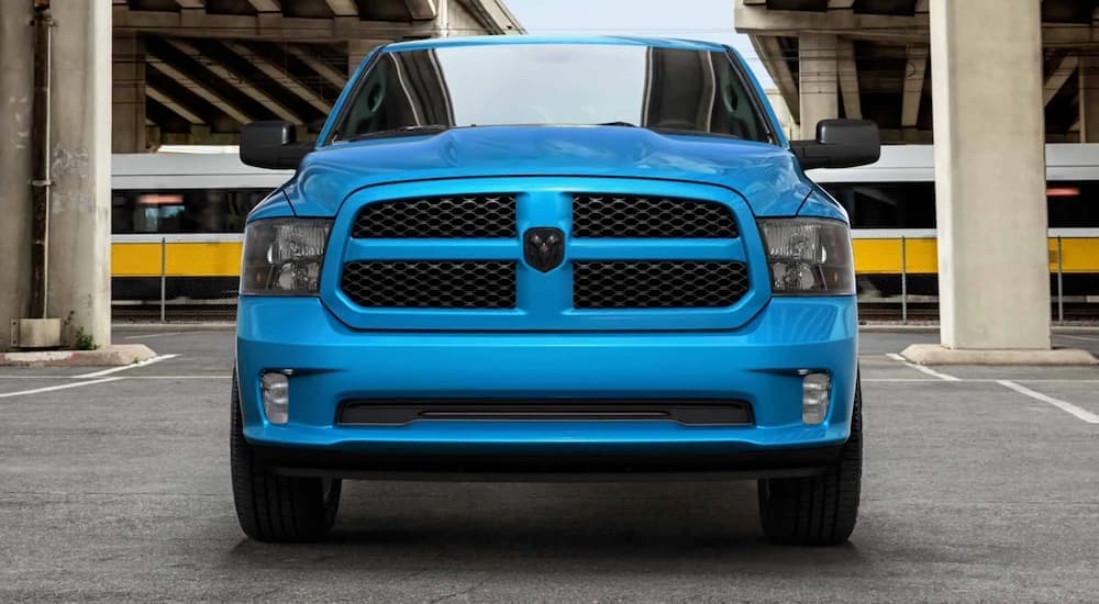 A blue 2020 Ram 1500 is shown from the front parked in a garage.
