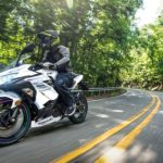 A white 2023 Kawasaki Ninja 400 is shown from the front at an angle after leaving a Kawasaki motorcycle dealer near me.