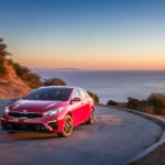 A red 2023 Kia Forte is shown from the front at an angle.