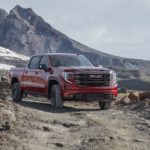 A red 2023 GMC Sierra 1500 AT4X is shown from the front at an angle.