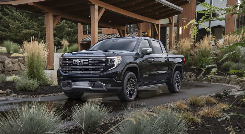 A black 2023 GMC Sierra 1500 Denali Ultimate is shown from the front at an angle.