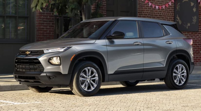 A grey 2023 Chevy Trailblazer is shown from the side parked on the street during a 2023 Chevy Trailblazer vs 2023 Honda HR-V comparison.