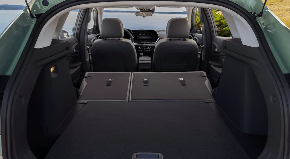 The rear cargo area of a green 2024 Chevy Trax is shown. 
