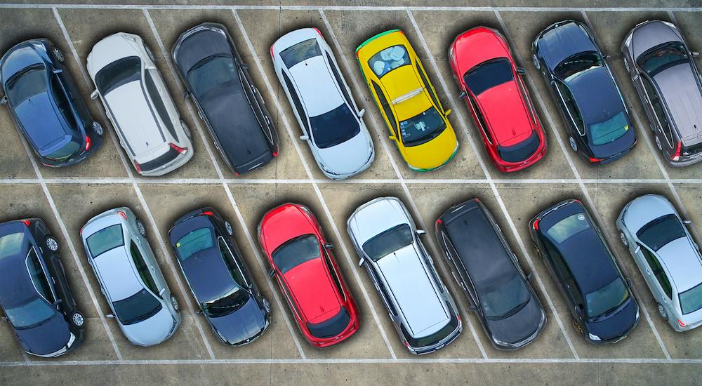 Two rows of parked cars are shown from a bird's eye view.
