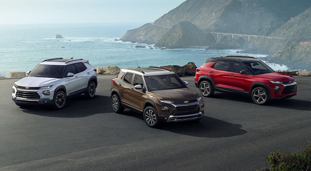 A white 2022 Chevy Trailblazer, bronze ACTIV, and red RS are shown near the ocean.
