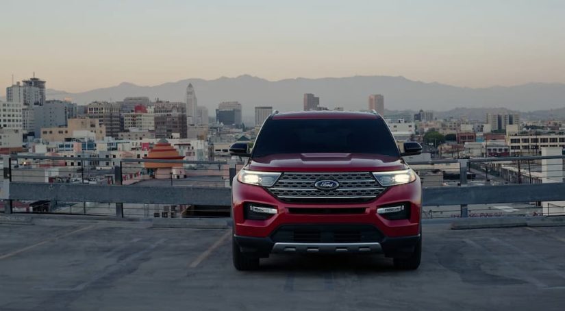 A red 2023 Ford Explorer Limited Hybrid is shown from the front parked on a parking garage.