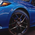A close-up of the wheel of a 2023 Honda Civic is shown from the front.