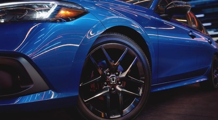 A close-up of the wheel of a 2023 Honda Civic is shown from the front.