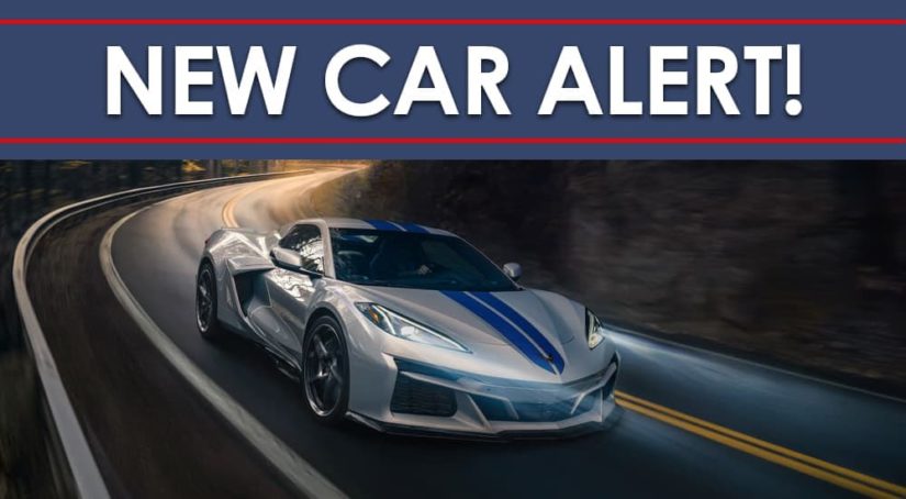 A silver 2024 Chevy Corvette E-Ray 3LZ is shown rounding a corner under a new car alert banner.