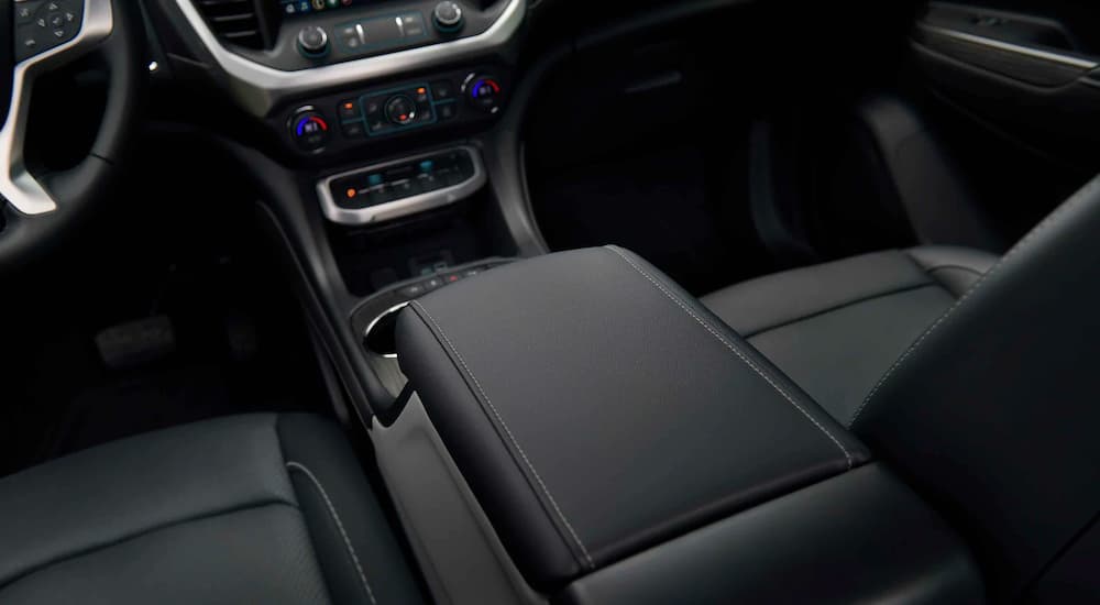 A close up shows the center console 2021 used GMC Acadia SLT.