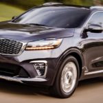 A black 2020 Kia Sorento is shown driving to a used Kia Sorento dealer.
