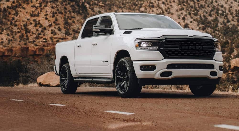 A white 2023 Ram 1500 is shown from the front at an angle during a 2023 GMC Sierra 1500 vs 2023 Ram 1500 comparison.